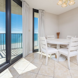 Dine at the round table while enjoying the expansive views through the beachfront balcony windows