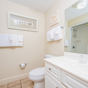 Enjoy a relaxing shower after a day of adventure in this guest bath with stylish accents and fluffy towels