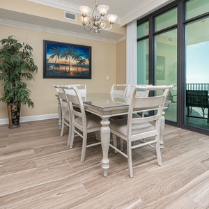 Gather around the elegant dining table, enjoying vibrant coastal views and creating lasting family memories