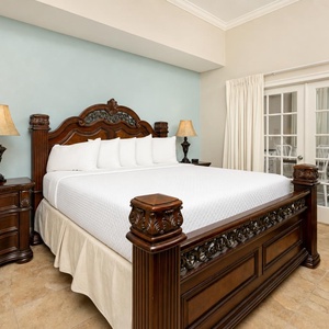 Rest in the plush king bed in the master as natural light floods through the glass doors, inviting tranquility and relaxation