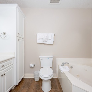 Indulge in a soothing soak in the luxurious jetted tub, complemented by plush towels and a calming ambiance