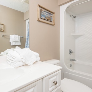 Freshen up in this guest bath in the relaxing shower or soothing tub before an exciting beach day