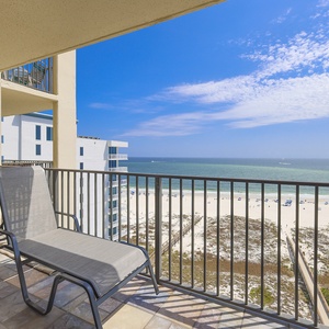 Relax on the balcony with a chaise lounge while enjoying sweeping views of the beach and turquoise gulf waters