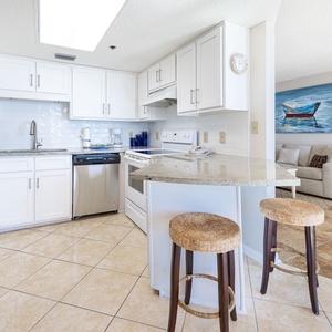 Gather around the kitchen bar, perfect for casual meals and conversations in a welcoming atmosphere