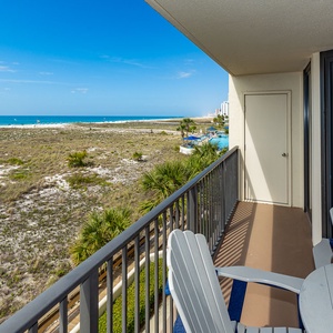 Balcony seating offers a tranquil view of the beach and gentle waves, perfect for enjoying the coastal breeze
