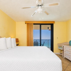 A king bed in the master suite invites peaceful rest with a view of the coast from the balcony