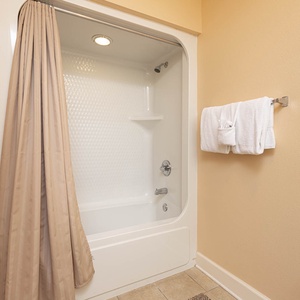 Indulge in serene moments in the soothing guest bath, enhanced by soft lighting and plush towels