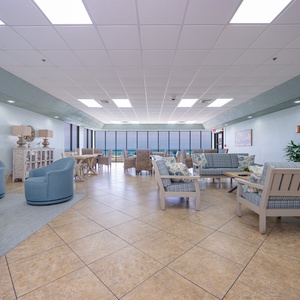 Relax in this inviting lounge with beach views, comfortable seating, and a cozy atmosphere perfect for unwinding