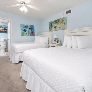 This guest suite with a queen and a double bed offers cheerful coastal artwork for peaceful stays