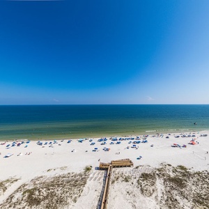 Imagine walking the boardwalk to the beachfront, pausing under umbrellas as the gulf glistens in the sun