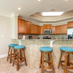 Sip your morning coffee at the breakfast bar and get ready for a beach day in this stylish space