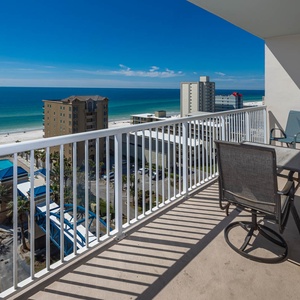 Enjoy a stunning beach view from the balcony, featuring comfortable seating and a perfect spot for relaxation