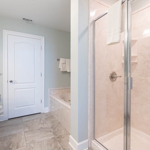 Sink into the jetted tub or enjoy a warm shower and feel soft towels waiting in this master bath