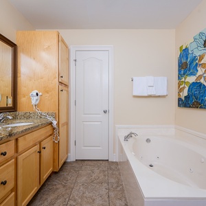Indulge in relaxation in the soothing whirlpool tub, surrounded by soft towels and an inviting vibe