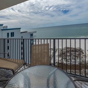 Balcony seating offers a relaxing spot to enjoy views of the tranquil gulf and the inviting beach just steps away