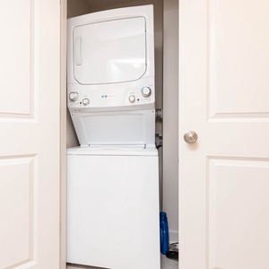 The laundry area features a stacked washer and dryer, providing convenience for guests during their stay