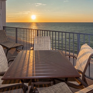 Watch the sun rise over the water while enjoying a meal at the outdoor table surrounded by comfortable seating