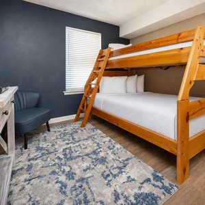 Relax in this guest room featuring a twin over full bunk bed, a double bed, and a TV for your entertainment