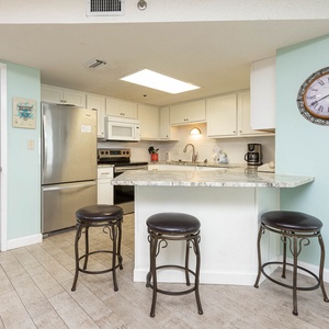 Gather around the stylish kitchen bar with seating, perfect for casual meals and morning coffee