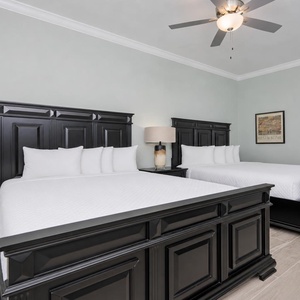 Rest comfortably in this inviting guest room featuring two queen beds, soft linens, and stylish lighting