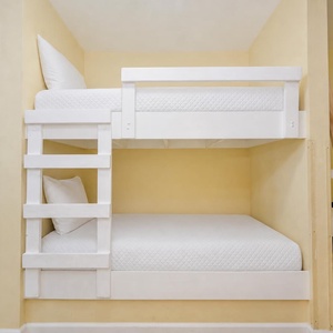 Rest your head in the bunk area where soft linens invite peaceful sleep after active beach days