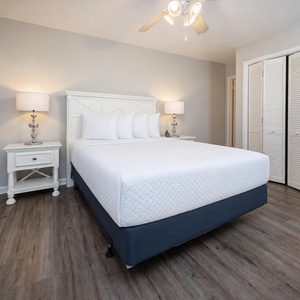Guest bedroom featuring a plush queen bed, stylish decor, and warm lighting for a cozy retreat
