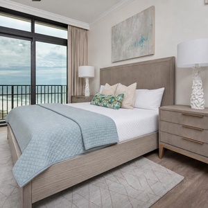 This bedroom features a serene view with a balcony, plush bedding, and a stylish lamp, perfect for relaxation