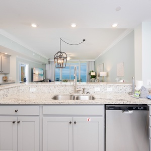 Rinse at the sink, feel the cool speckled countertop, and watch the gulf glimmer through the living room