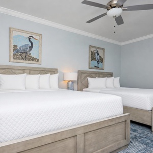 Sleep peacefully with soft linens adorning two queen beds and coastal artwork