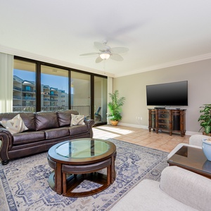 Relax on the cozy sofa with a queen sleeper in this inviting family room with beautiful balcony views