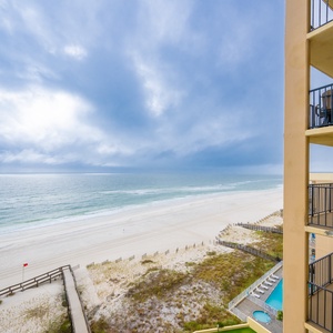 This balcony offers a serene view of the sandy beach and tranquil waters, perfect for relaxation