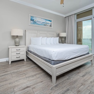 Retreat to the king master suite with cozy bedding and drift off to the sound of the waves from the balcony