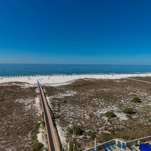 Stunning view of the beach and turquoise umbrellas, showcasing a serene gulf backdrop under a clear blue sky