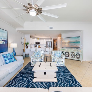 Sink into plush seating, sharing laughter and stories as the coastal vibe of this inviting living area surrounds you
