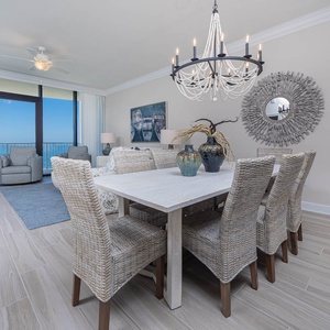 Dine at the elegant table while enjoying the serene view from the comfortable seating area nearby