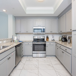 Enjoy cooking in this inviting kitchen with speckled stone counters, a coffee corner, and sleek design