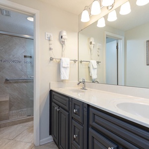 Enjoy the spacious master bath featuring dual sinks, modern fixtures, and a walk-in shower for your convenience