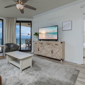 Relax in the inviting living area with a sofa with queen sleeper, large TV, and stunning beach views