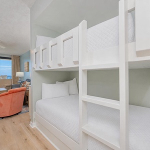 Two bunk beds in the living space offer restful spots for kids while you relax nearby with coastal views