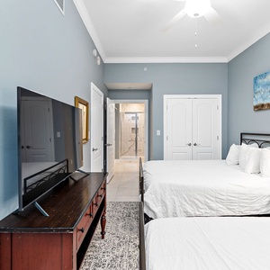 Relax with your favorite show on one of the plush queen beds in this guest suite
