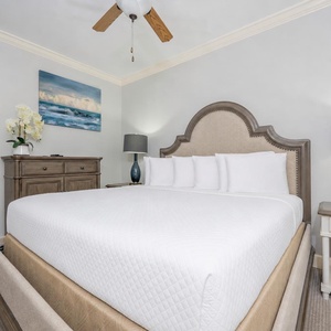 Cozy king guest suite with gentle fan breezes offer calm as you rest against fluffy pillows