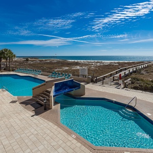 Enjoy the inviting pool area with a relaxing atmosphere and easy access to the beach just steps away