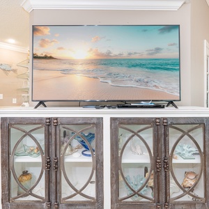 Relax in front of the large TV, enjoying movie nights with loved ones while surrounded by coastal decor