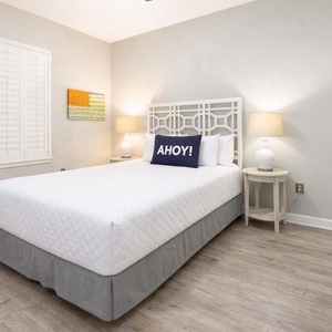 Rest comfortably in this inviting guest bedroom, where a queen bed awaits you after a day of beach adventures