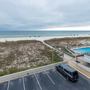 Enjoy a tranquil view of the pristine beach and inviting pool from this relaxing vacation rental