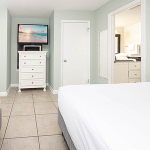 Relax in this guest bedroom with two comfortable queen beds, a TV, and adjoining bathroom