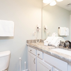 Freshen up in this guest bath in the relaxing shower or soothing tub before an exciting beach day