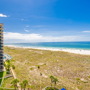 Expansive views of the beach highlight the serene coastal setting from the balcony, inviting relaxation and enjoyment