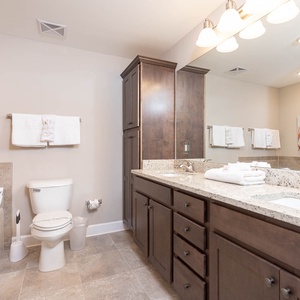 Refresh in the master bath after a day at the beach with a soothing tub and relaxing walk-in shower