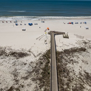 Stroll along the beach, where colorful chairs await your relaxation under the sun